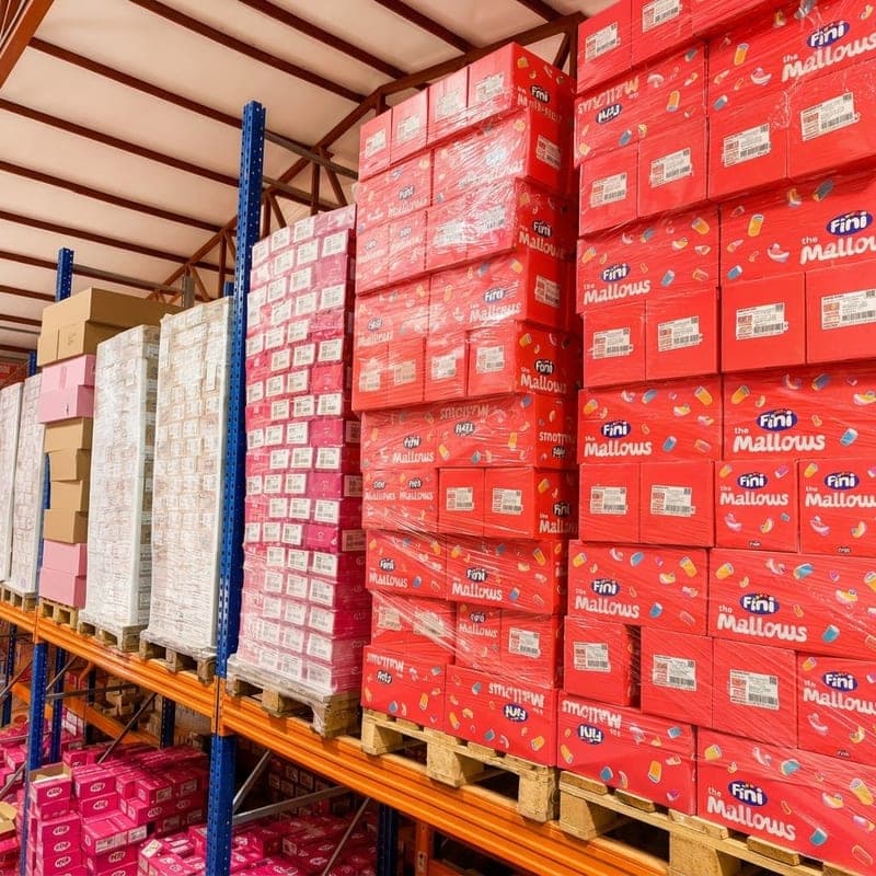 Confectionery cases stacked on pallets on high racking