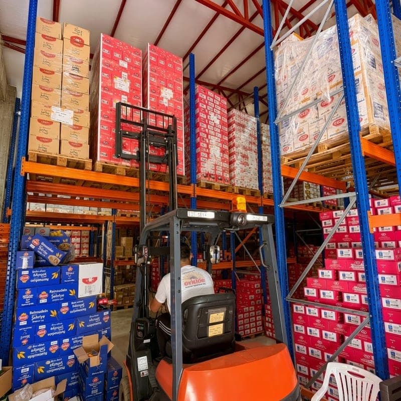 An ENTAM employee operating a forklift at the ENTAM central warehouse